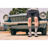 classic car, muscle car, shorts, sky, trees, blue, green, road, pavement, socks, crew socks.