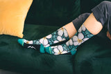 couch, socks in action, live modeled, pillow, pants, green, gold, yellow, orange, shades of blue