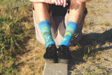 Live action modeled socks, black shoes, field, blue crew socks, house, rising sun, addiction recovery.