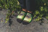 ankle socks shot, green foliage, plants, nature, black cuff,pavement